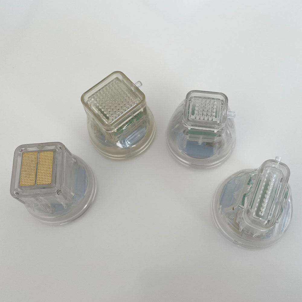 Close-up of transparent microneedling replacement cartridge showing internal needle mechanism and spring components.