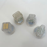 Close-up of transparent microneedling replacement cartridge showing internal needle mechanism and spring components.